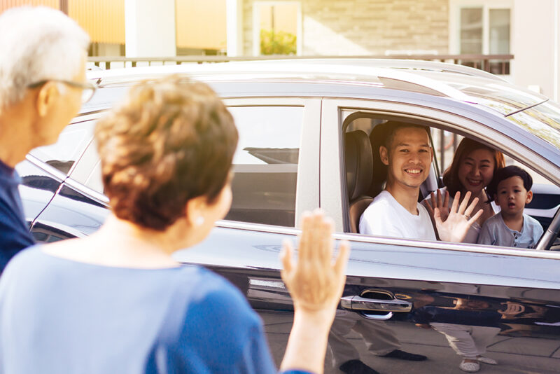 Asian,Family,Of,Father,,Mother,And,Son,Waving,Goodbye,To