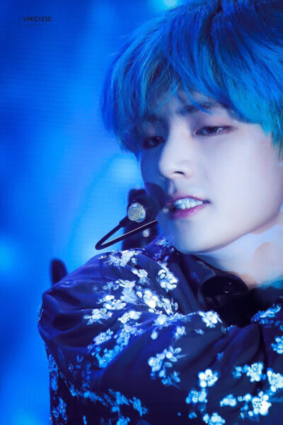 Ảnh V tóc xanh đang biểu diễn